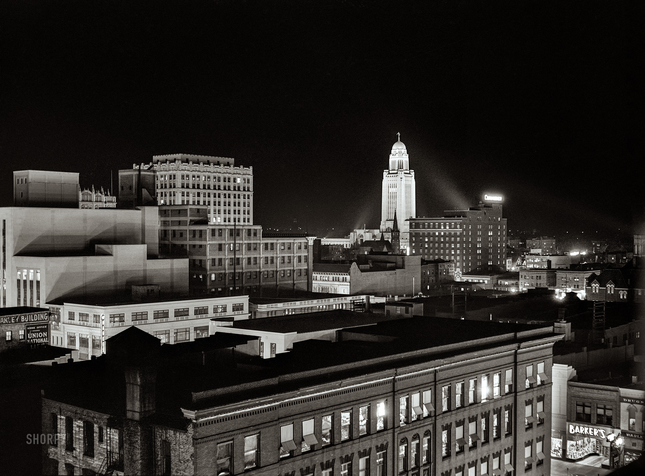 November 1940. "Lincoln, Nebraska. State capitol in background." Medium format acetate negative by John Vachon for the Farm Security Administration. View full size.