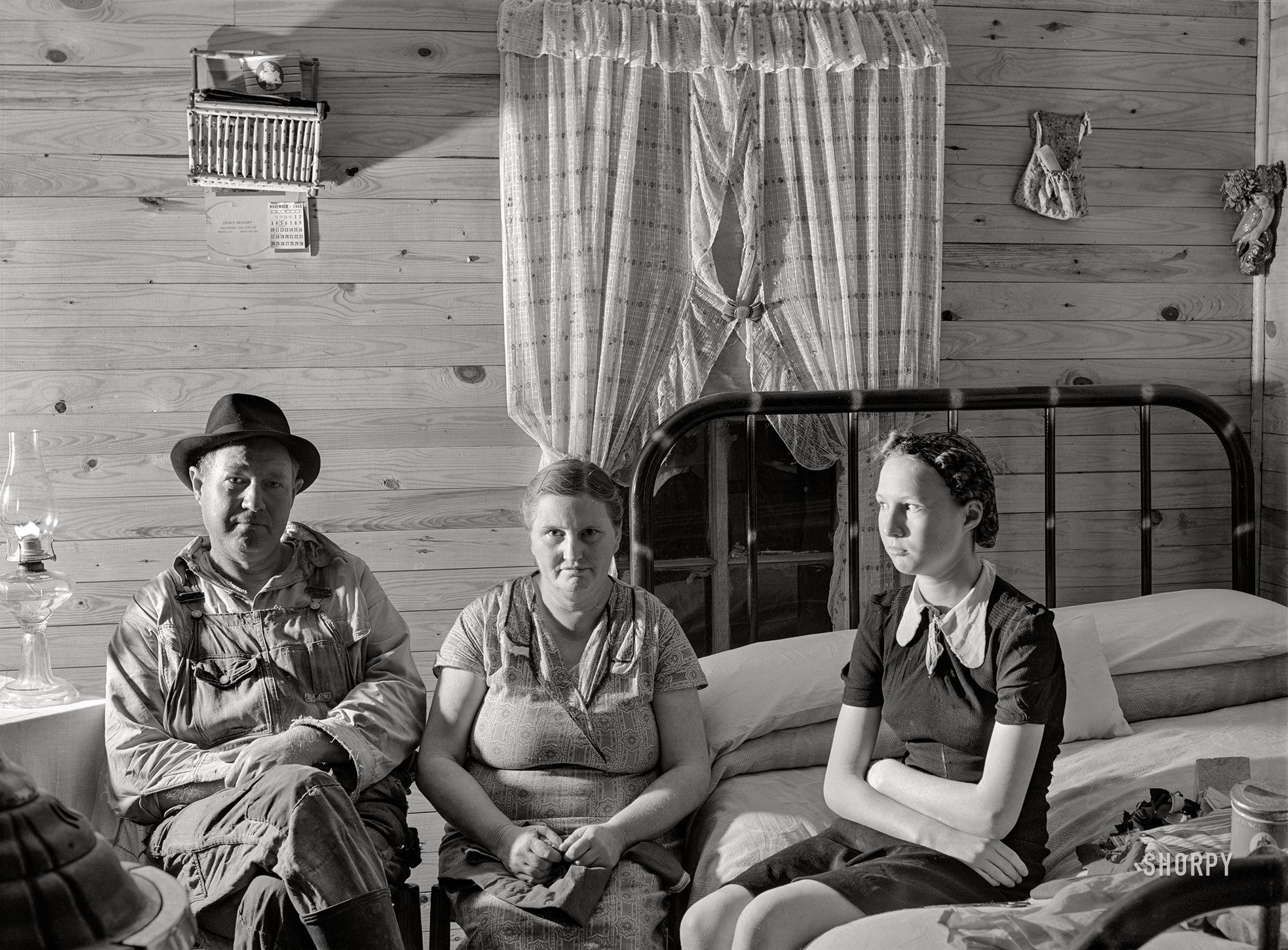 November 1940. "Agricultural day laborer, wife and daughter in new home built by the FSA. Delmo labor homes project, New Madrid County, Missouri." Medium format acetate negative by John Vachon for the Farm Security Administration. View full size.