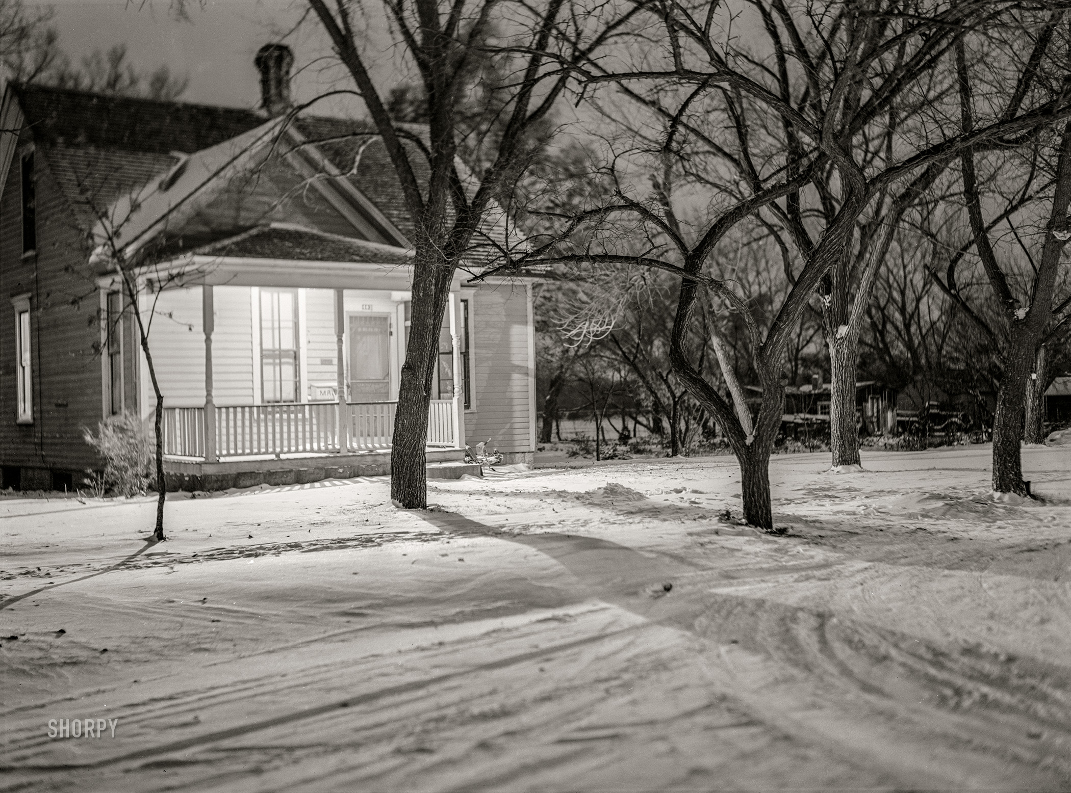 November 1940. "Porch light to welcome expected visitors. Pierre, South Dakota." Medium format acetate negative by John Vachon for the Farm Security Administration. View full size.