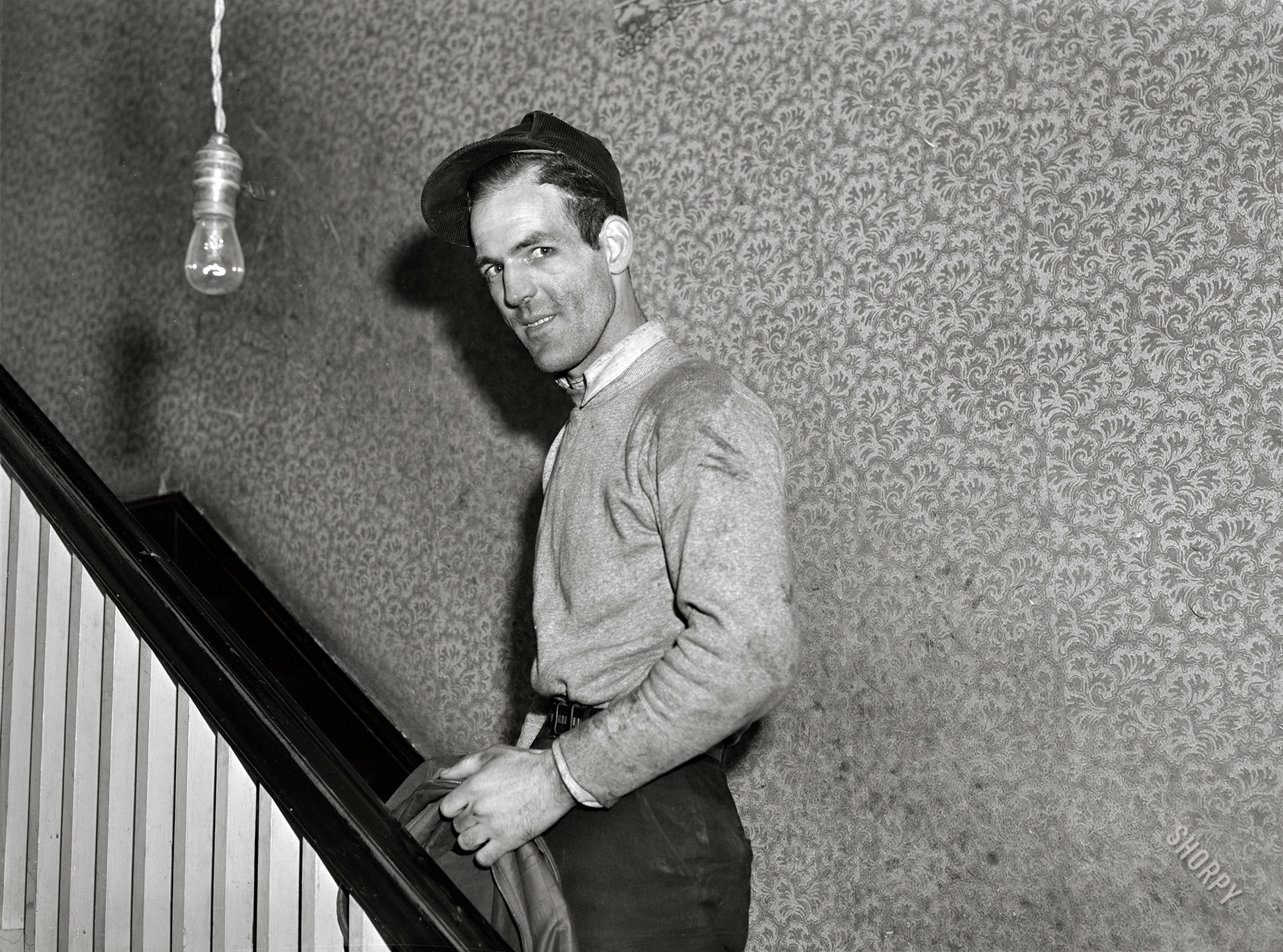 December 1940. Radford, Virginia. "Hercules Powder Plant employee going upstairs. Mrs. Pritchard's boardinghouse. Eighteen men board here." One of the gents last seen here. Acetate negative by John Vachon for the Farm Security Administration. View full size.