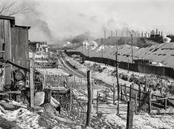 January 1941. Midland, Pennsylvania. "Backyards of company houses and steel mill." Medium format acetate negative by John Vachon for the Farm Security Administration. View full size.
Big changes comingJust across the Ohio River, perhaps a mile from the site of this photograph, stands the Beaver Valley Nuclear Power Station. 
(The Gallery, Factories, John Vachon, Railroads)