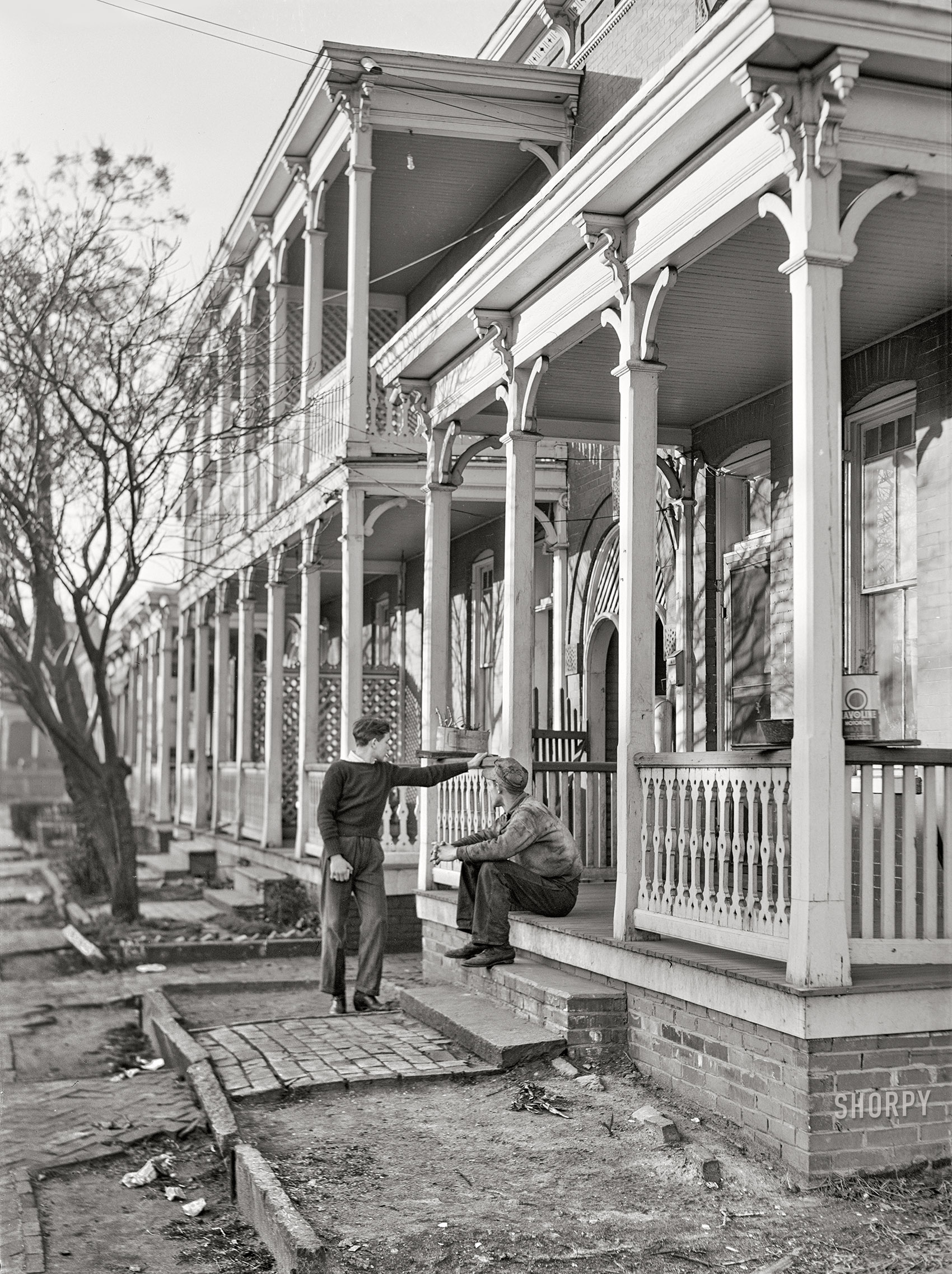March 1941. "Defense workers in front of rooming houses. Norfolk, Virginia." Medium format acetate negative by John Vachon for the Farm Security Administration. View full size.