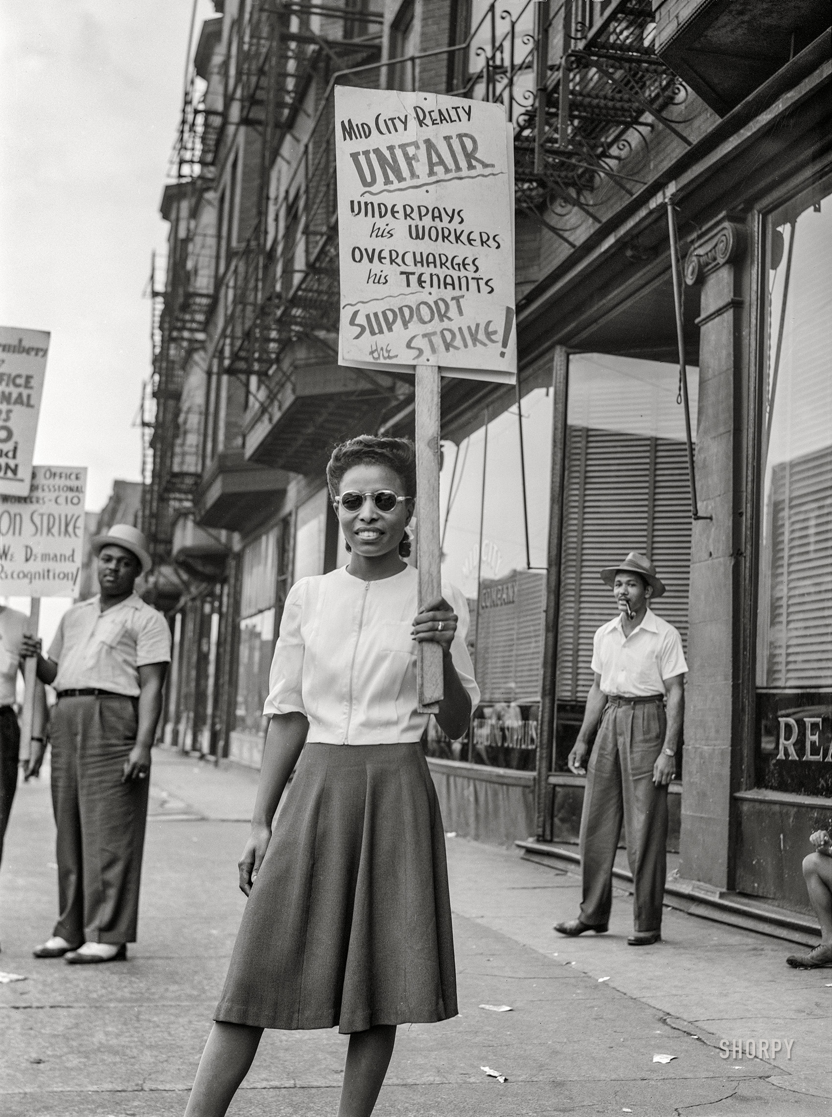 July 1941. "Girl in picket line. Union picketing for increase of $8 weekly wage. Mid-City Realty Company, South Chicago, Illinois." Acetate negative by John Vachon. View full size.