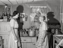 July 1941. "Wife of FSA borrower discussing pressure cooker with home supervisor. Mille Lacs County, Minnesota." Medium format negative by John Vachon. View full size.