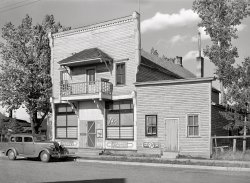 August 1941. "Building in Ewen, Michigan, former lumber town on the Upper Peninsula." Acetate negative by John Vachon for the Farm Security Administration. View full size.
Car ID1937 Graham Crusader.
Non-PC Car NamesGood eye, Hayslip. That's a very obscure auto to identify. "Crusader" would definitely not fly as an appropriate model name in today's world. Neither would the Studebaker "Dictator." In fact, "Dictator" probably became non-PC in the U.S. sometime around December 7, 1941.
[And who could forget the Fiat Fascist? - Dave]
Not the UtilityThe window is advertising Power House candy bars, made by Peter Paul (discontinued).
(The Gallery, John Vachon, Small Towns, Stores & Markets)