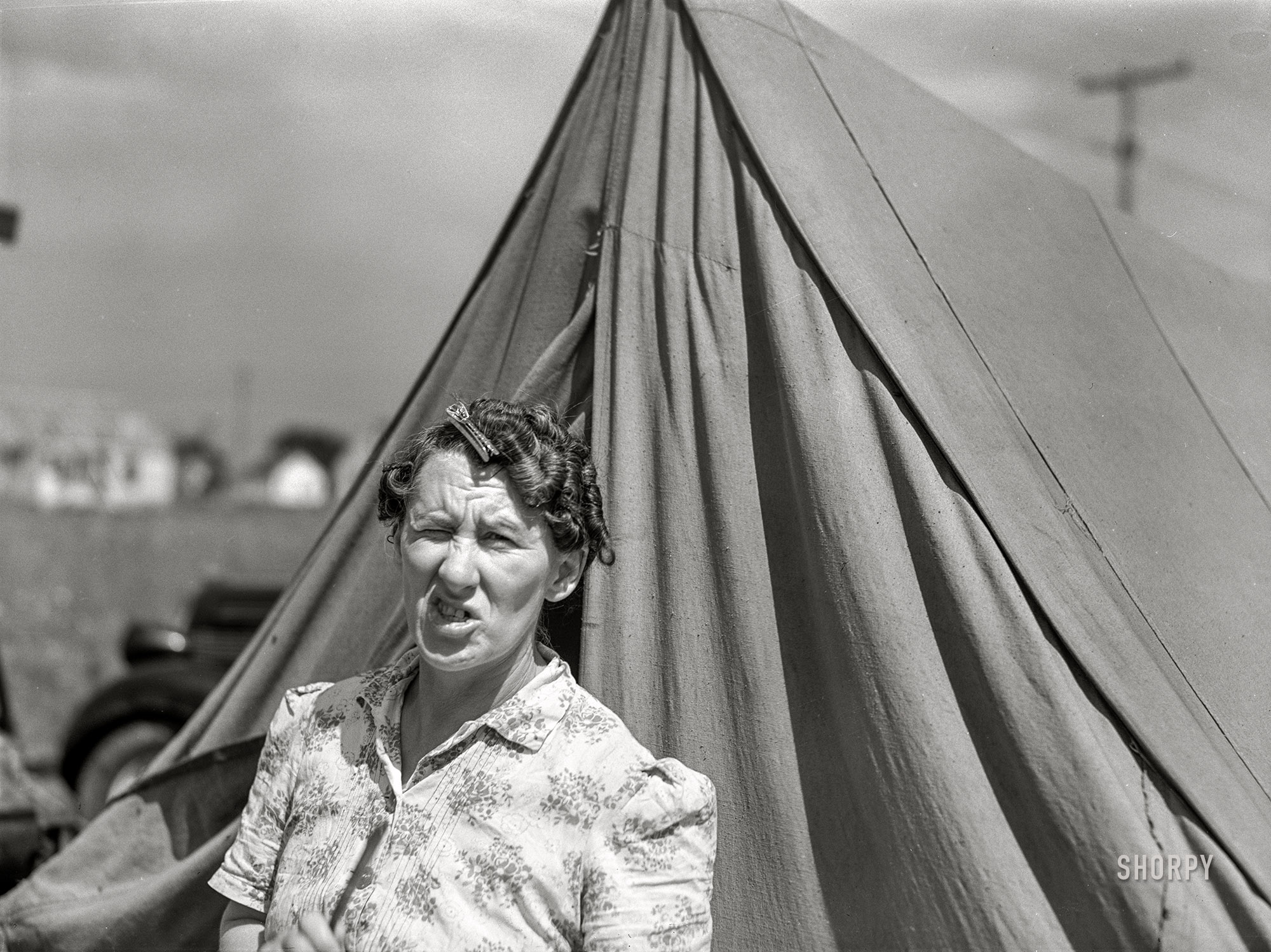 August 1941. "Mrs. Ash, wife of defense worker. They are living in a tent beside the foundation of their new home which they are building themselves. Outskirts of Detroit, Michigan." Medium format acetate negative by John Vachon for the Farm Security Administration. View full size.