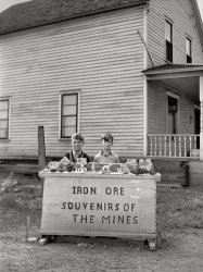 August 1941. "Children of old Hibbing, Minnesota, the part of town which is gradually being torn down as mining operations expand, sell pieces of ore and iron range souvenirs to tourists." Acetate negative by John Vachon for the Farm Security Administration. View full size.