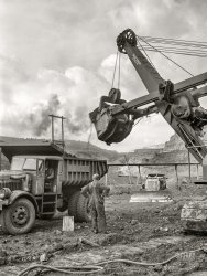 &nbsp; &nbsp; &nbsp; &nbsp; Dart truck with Hercules dump body; Bucyrus-Erie 54-B electric shovel.
August 1941. "Loading dump truck with iron ore at the Albany mine, Hibbing, Minnesota.  Use of trucks was initiated in this mine two years ago and railroad tracks removed; trucks were found more economical and can climb the steep grade in much shorter time." Medium format acetate negative by John Vachon for the Farm Security Administration. View full size.