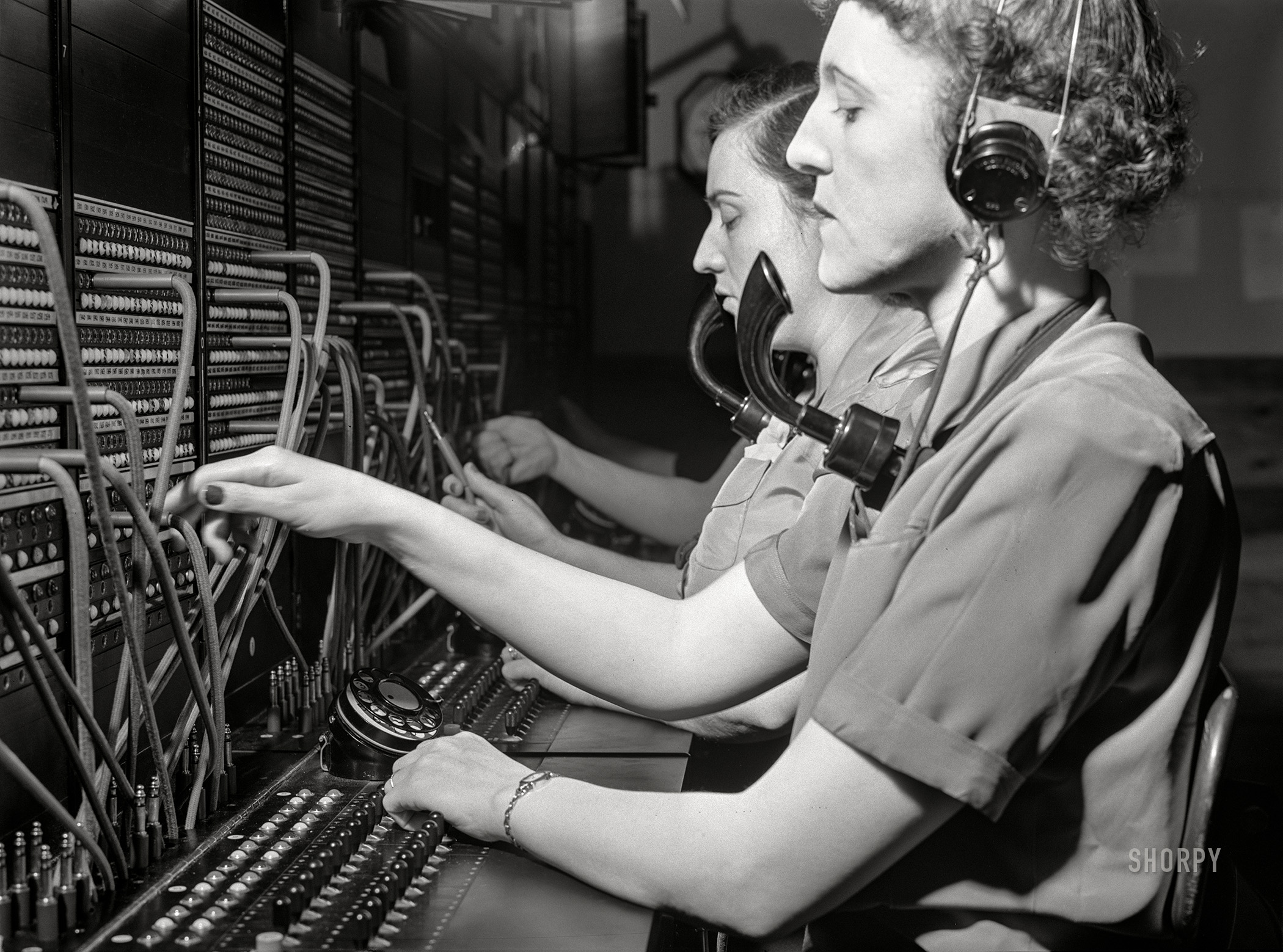 December 1941. "Telephone operators at Aberdeen proving grounds. They live in dormitory for defense workers. Aberdeen, Maryland." Acetate negative by John Vachon. View full size.