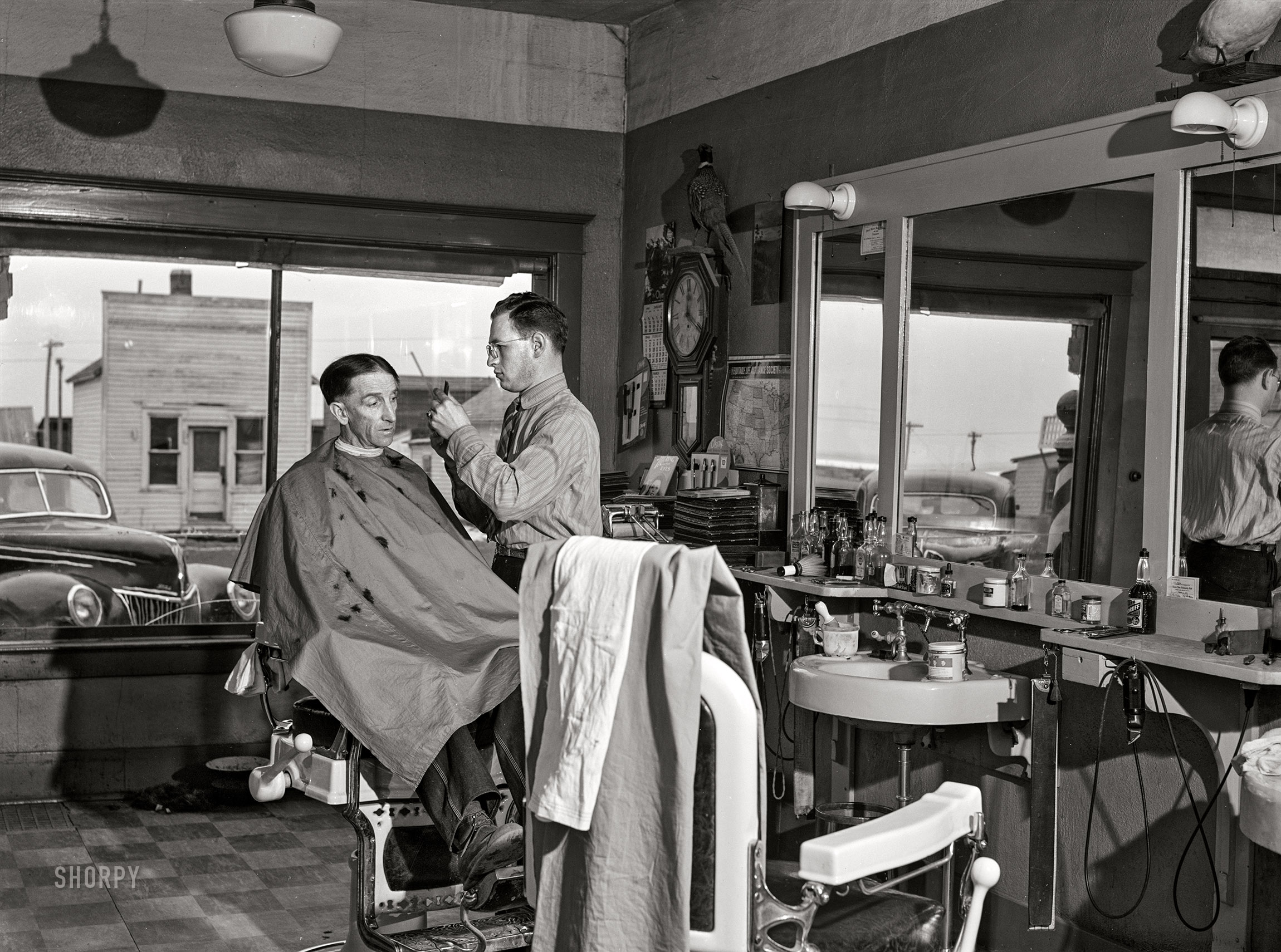 February 1942. "Timber Lake, Dewey County, South Dakota. Barber shop." Medium format acetate negative by John Vachon for the Office of War Information. View full size.
