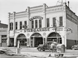 April 1942. "Missoula, Montana. Garage." More  curbside gas pumps! Medium format acetate negative by John Vachon for the Farm Security Administration. View full size.