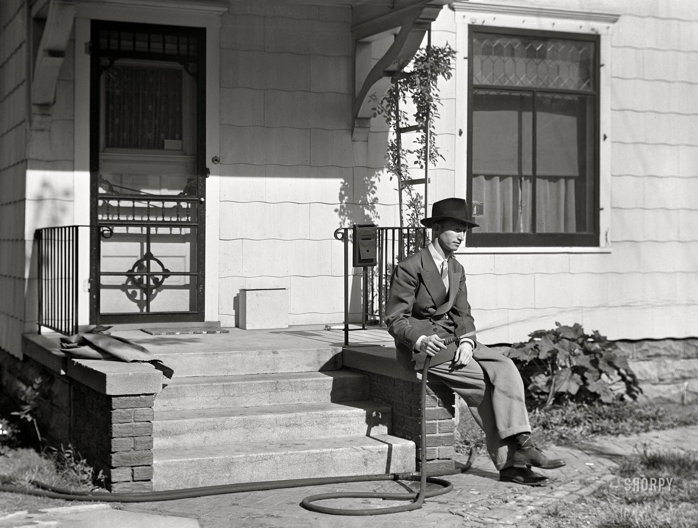 May 1942. It's that crap-shooting gent from Grand Island, Nebraska, in the second of eight enigmatic, uncaptioned exposures credited to John Vachon. View full size.