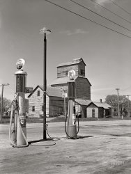 May 1942. "Gothenburg, Nebraska. Gas station and grain elevator." Medium format acetate negative by John Vachon for the Farm Security Administration. View full size.