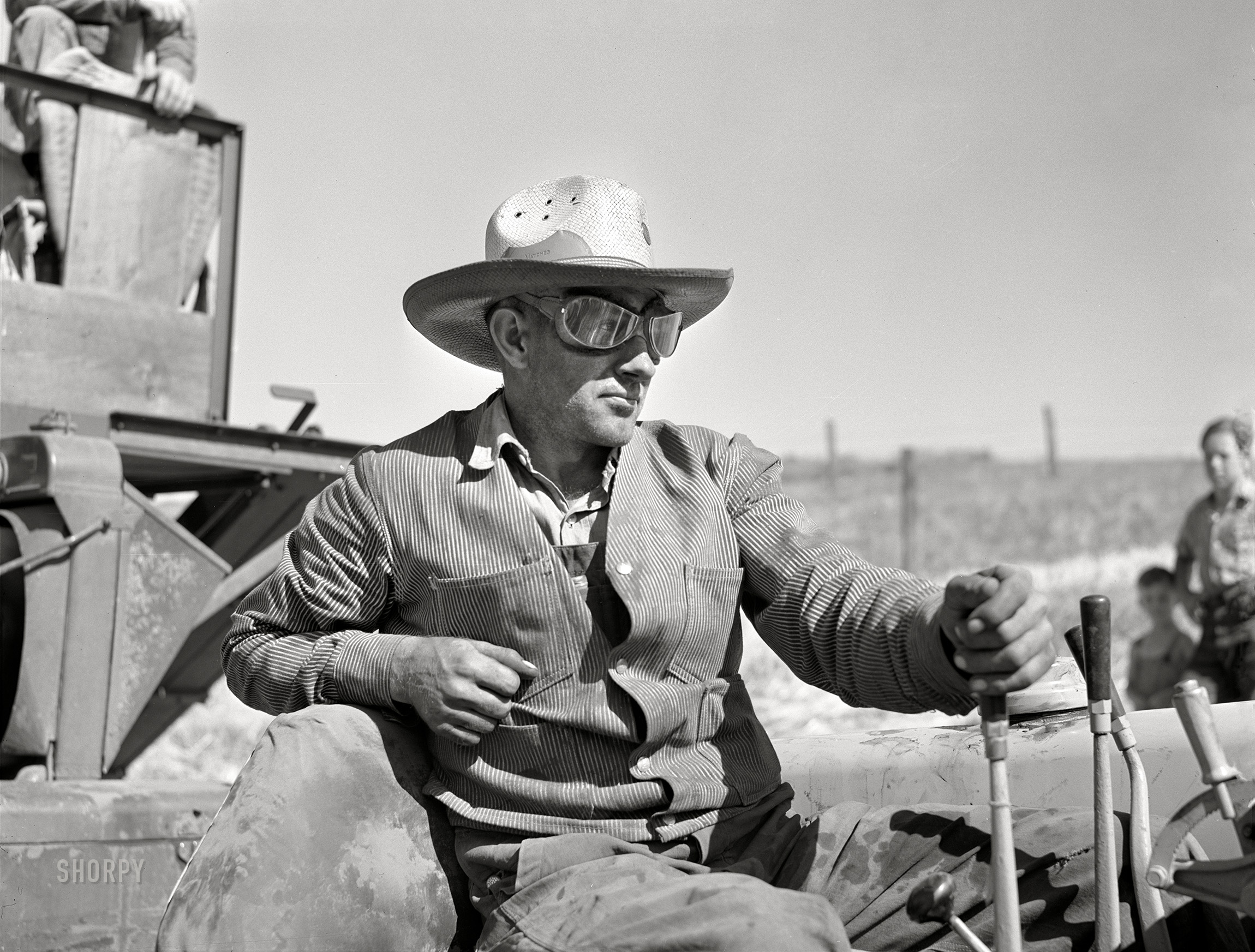 July 1941. "Driver of caterpillar tractor which draws combine in wheat fields of Whitman County, Washington." Photo by Russell Lee for the Farm Security Administration. View full size.