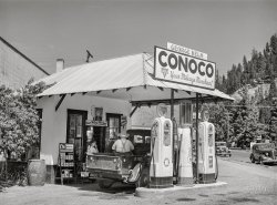 July 1941. "Filling station. Orofino, Idaho." At "Your Mileage Merchant," a choice of Conoco DEMAND or BRONZ-Z-Z. Photo by Russell Lee, Farm Security Administration. View full size.