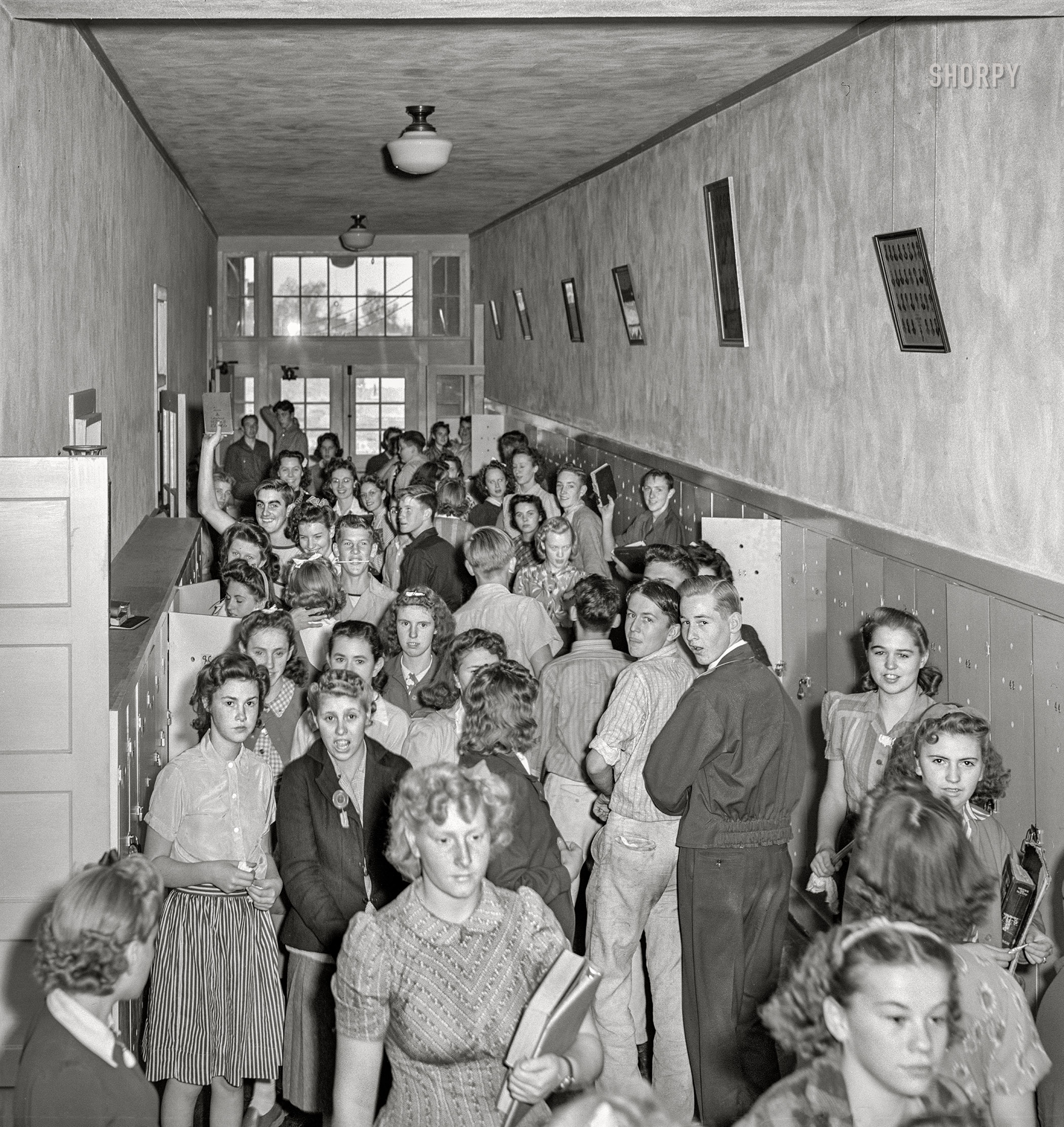September 1941. Hermiston, Oregon. "Crowded halls in high school between classes." Another look at the Kids in the Hall last seen here, including That Guy With the Eyebrows. Medium format acetate negative by Russell Lee for the Farm Security Administration. View full size.