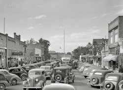 September 1941. "Traffic on main street of Hermiston, Oregon. Defense boom town housing workers for the Umatilla Ordnance Depot." Acetate negative by Russell Lee. View full size.
