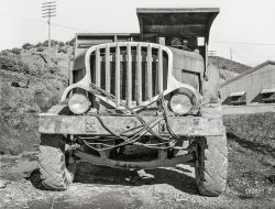 December 1941. Shasta County, California. "Dump truck which carries materials for use in construction of Shasta Dam. This truck uses butane instead of gasoline because of the extra power butane gives." Medium format acetate negative by Russell Lee. View full size.