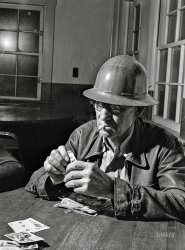 December 1941. "Workman at Shasta Dam plays poker. Shasta County, California." Medium format acetate negative by Russell Lee for the Farm Security Administration. View full size.