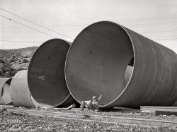 &nbsp; &nbsp; &nbsp; &nbsp; "INSTRUCTIONS: Grasping firmly, insert Segment 49E into 49F ... "
December 1941. Shasta County, California. "Segments of penstock pipe which will be used to conduct water from the reservoir formed by Shasta Dam to the hydroelectric turbines." Acetate negative by Russell Lee for the Farm Security Administration. View full size.