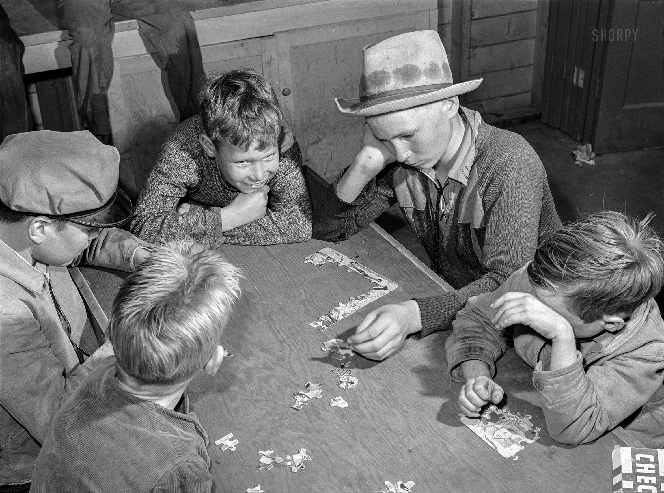 January 1942. Woodville, California. "FSA farm workers' community. Games are played in the recreation room in the community building." Medium format acetate negative by Russell Lee for the Farm Security Administration. View full size.