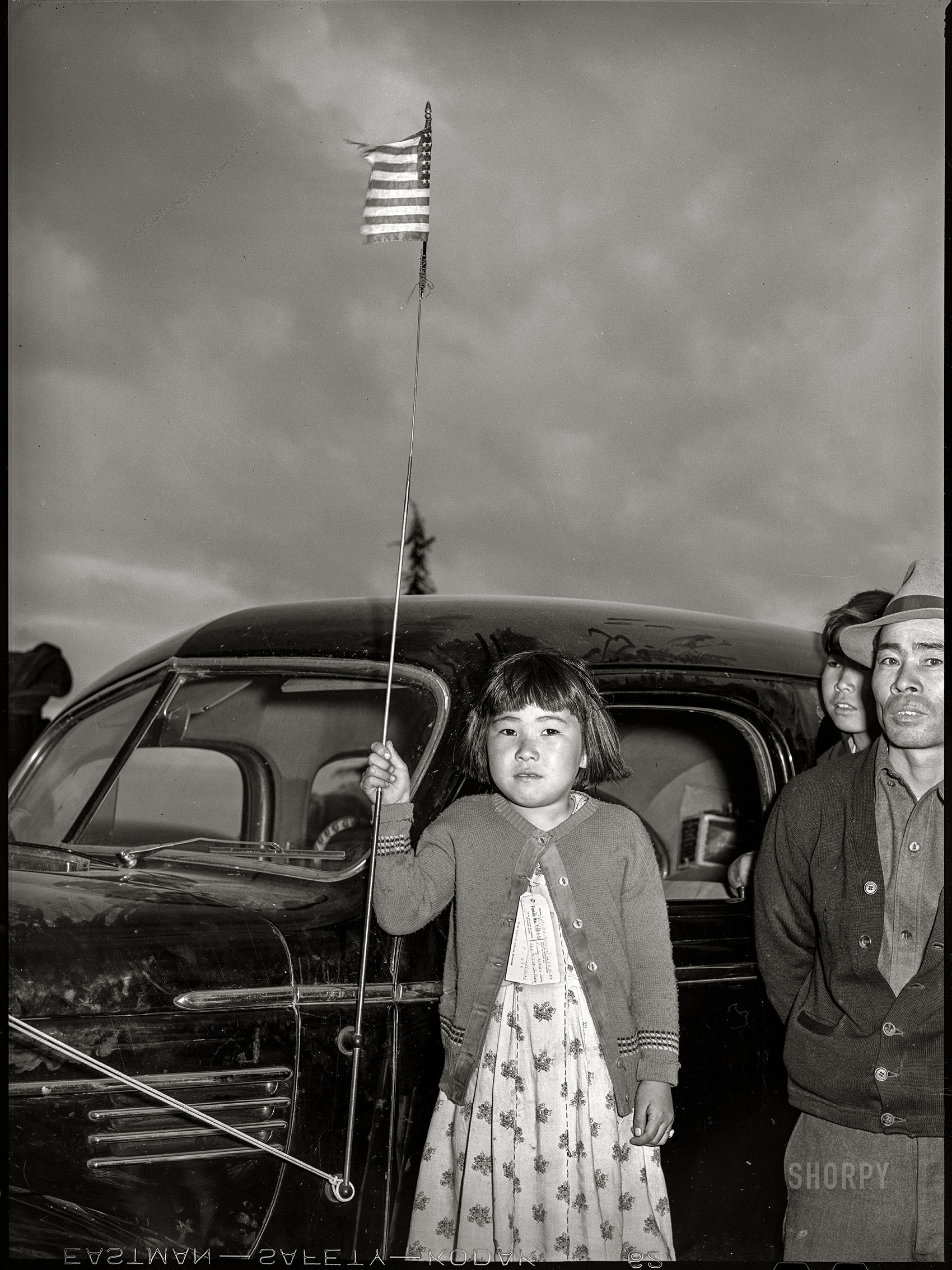 April 1942. "Santa Anita reception center, Los Angeles County, California. The evacuation of Japanese and Japanese-Americans from West Coast areas under United States Army war emergency order. Japanese family arriving at the center." Medium format acetate negative by Russell Lee for the Office of War Information. View full size.
