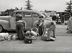 April 1942. "Santa Anita reception center, Los Angeles County, California. The evacuation of Japanese and Japanese-Americans from West Coast areas under United States Army war emergency order. Examining baggage of Japanese as they arrive at the center." Acetate negative by Russell Lee for the Office of War Information. View full size.