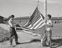 July 1942. "Rupert, Idaho. Former CCC camp now under FSA management. Japanese-Americans taking down their flag in the evening." Internees at the Minidoka War Relocation Center. Acetate negative by Russell Lee for the Farm Security Administration. View full size.