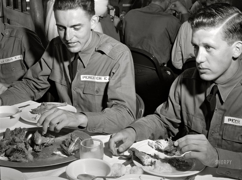 August 1941. "Poultry raised under FSA 'Food for Defense' program feeds Army flight trainees. Cadet E.A. Peresich Jr. takes his third helping of fried chicken. Craig Field, Southeastern Air Training Center, Selma, Alabama." Photo by John Collier, Farm Security Admin. View full size.
