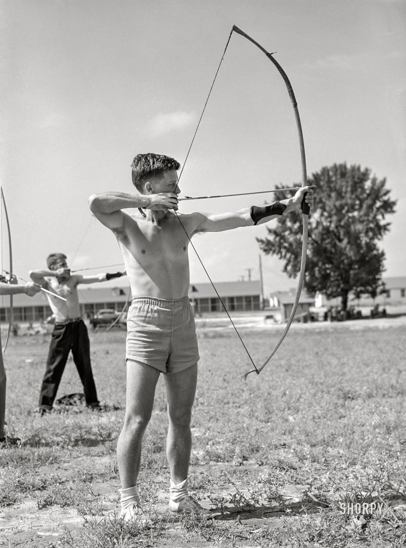 August 1941. "Recreation -- archery. Southeastern Air Training Center, Craig Field, Selma, Alabama." Army Air Cadet Peck, last seen here, gets ready to let one fly. Medium format acetate negative by John Collier for the Farm Security Administration. View full size.
