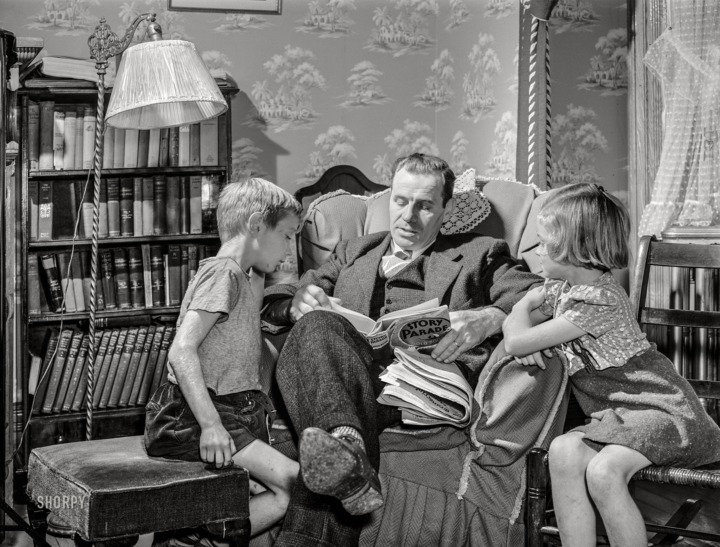 October 1941. "Williamstown, Massachusetts. Father reading to his children." Medium format acetate negative by John Collier for the Farm Security Administration. View full size.