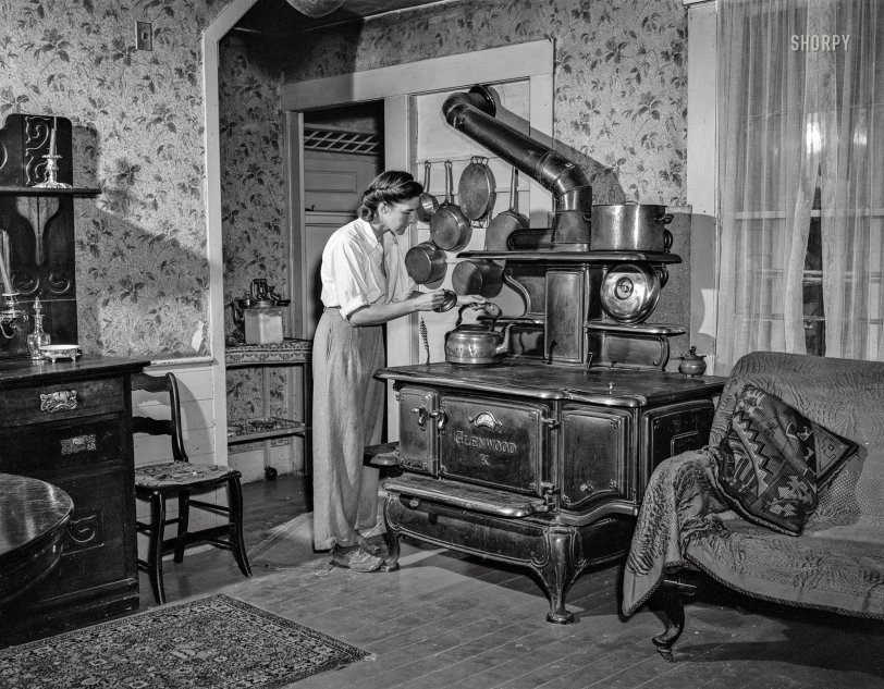 August 1942. "Hartford, Connecticut (vicinity). U.S. residents, formerly Europeans, or of European descent, settled on small farms in central Connecticut. Mrs. Boris Komorosky in her living room. Stove is for heat in winter, Russian style!" Photo by John Collier. View full size.