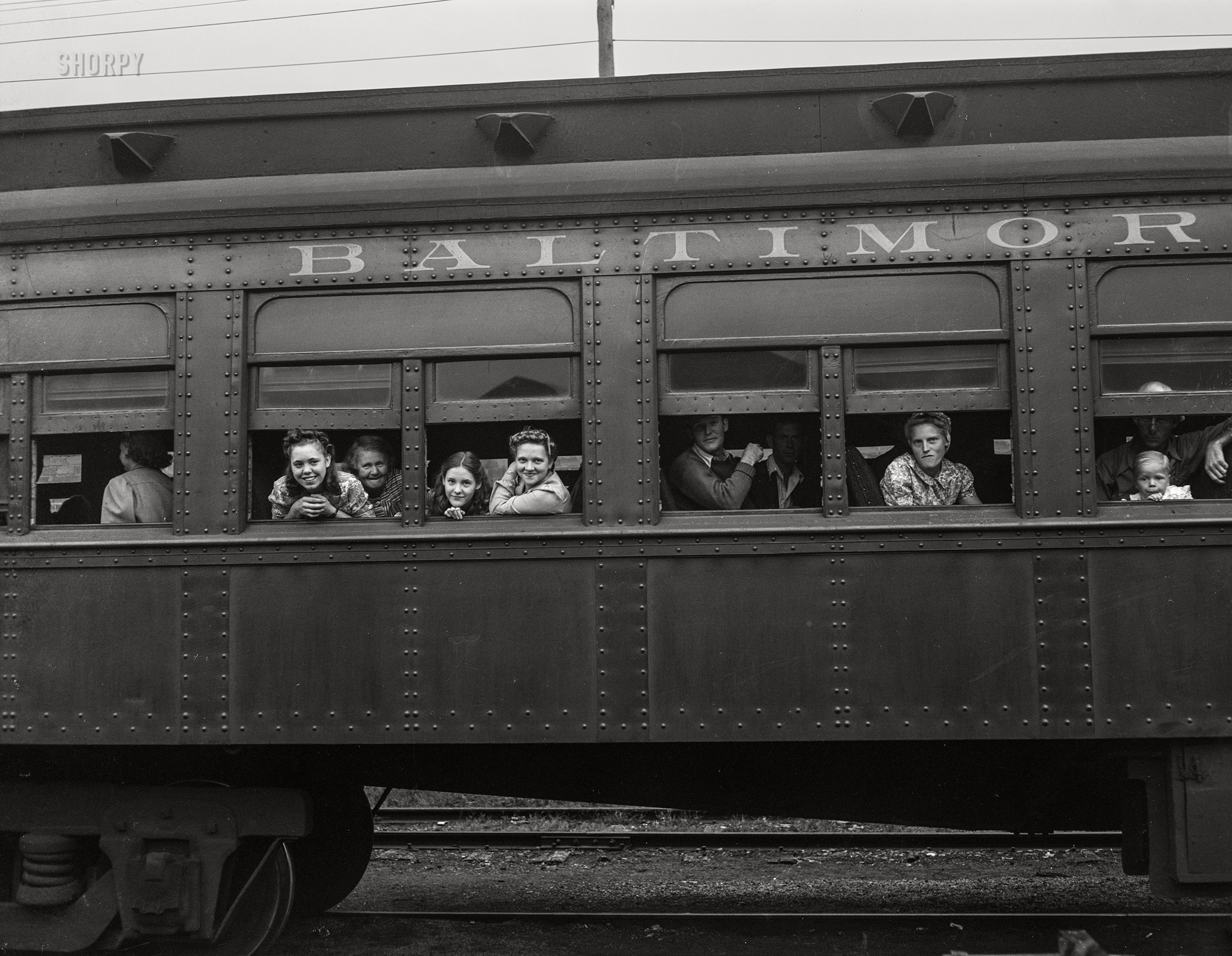 September 1942. Richwood, West Virginia. "Trainload of migratory workers (mostly high school students, many accompanied by family members) in day coach bound for the harvest fields in New York state." Photo by John Collier for the Farm Security Administration. View full size.