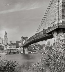Spring 1941. "View under Roebling Suspension Bridge of Cincinnati from Kentucky side of the Ohio River. Waterfront showing numerous business houses: Colter Grocers, Cincinnati Grain & Hay, King Bag, Queen City Rag & Paper and others." 4x5 inch acetate negative. View full size.