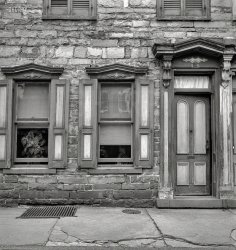 August 1940. "Old house on Race Street in Mauch Chunk, Pennsylvania." Photo by Jack Delano for the Resettlement Administration. View full size.
Great to see it&#039;s still with usLooks like she was overdue for tuckpointing in 1940. Urban renewal would've probably taken it if it were in a major city.
There is a song about Mauch Chunk. Part of it goes
 When old Mauch Chunk was young
 And Captain Ables preached
 The top notch of intemperance
 by many of one was reached
 And dark the cloud of sorrow
 O're many a dwelling hung
 With deep disgrace and poverty
 When old Mauch Chunk was young
It warms your heartAfter enlarging this picture and seeing the thriving, lush green plant and the animated human figures through the windows, this photo is no longer just a cold, stone building but reveals a place where life is happening and it instantly becomes much more inviting.
Now Jim Thorpe, Pa.Now it is a beautiful quaint town with loads of tourists, probably the nicest little town in Pa.
Wonderful little townMy wife and I spent a whole day there in 2004 while visiting in the Poconos. I highly recommend the Asa Packer Mansion and the jail where the Molly Maquires were incarcerated and executed. It was summer and the town was beautiful with flowers and incredible landscaping.
Built in 1849 and still thereThis 4-bedroom townhouse in Jim Thorpe (renamed from Mauch Chunk and East Mauch Chunk in 1954) was sold to a new owner in March.
It&#039;s a Honey!I'd resettle there in a heartbeat.
Slate sidewalkCheck out the hand cut slate sidewalk. 
(The Gallery, Jack Delano)