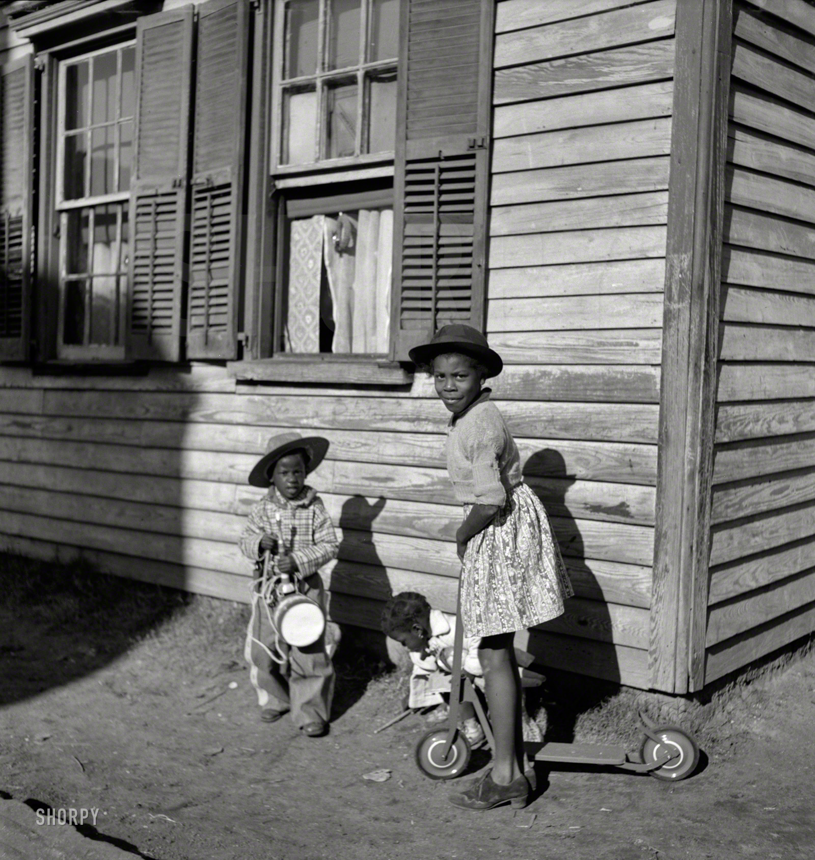 December 1938. "Negro home near Charleston, South Carolina." The little gunslinger wearing a "Buck Jones" cowboy outfit. Medium format negative by Marion Post Wolcott for the Resettlement Administration. View full size.