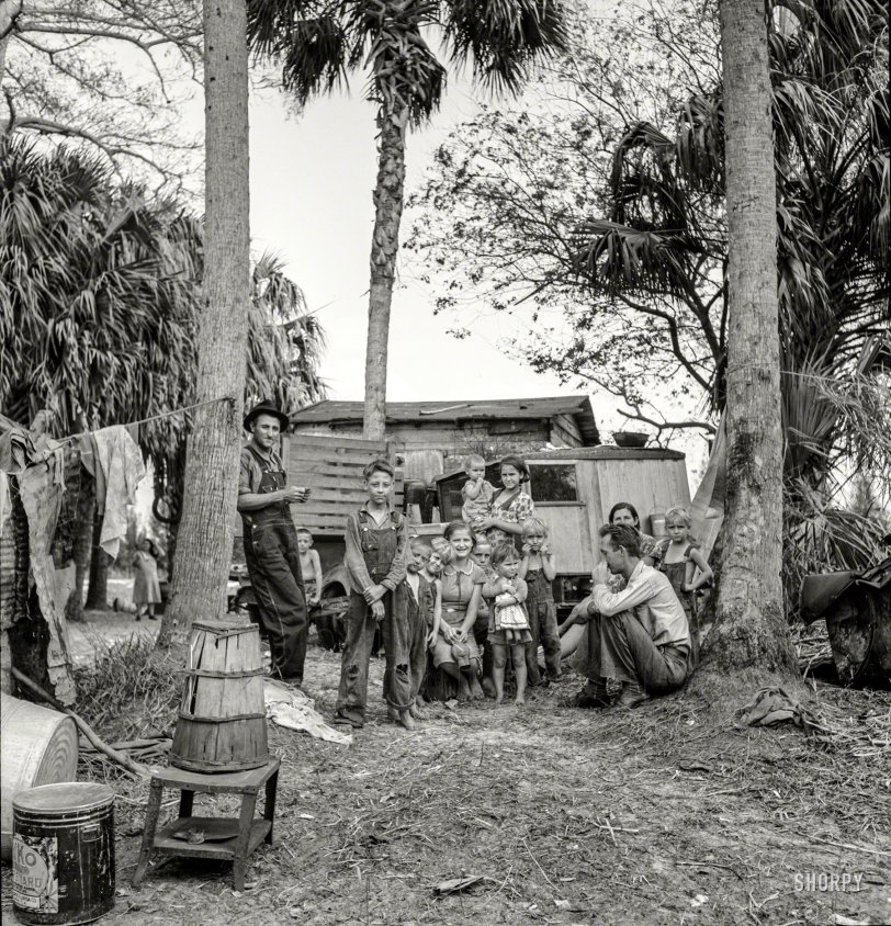 February 1939. "Migrant laborers' camp near Canal Point, Florida. In foreground is a bean hamper which they use to sit on and they call a 'muck rocker.' Some of them are from Missouri and Arkansas." Medium format negative by Marion Post Wolcott for the Resettlement Administration. View full size.
