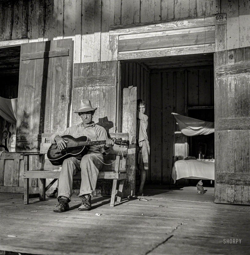 August 1940. "Farmer playing guitar on the porch in the evening. Near Natchitoches, Louisiana." Medium format nitrate negative by Marion Post Wolcott for the Resettlement Administration. View full size.
