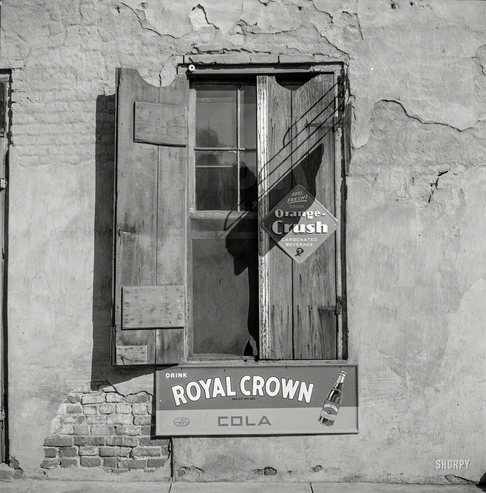 August 1940. "Natchez, Mississippi, grocery window." Illustrating the gradual accretion of soft-drink signage on retail stores like barnacles on the hull of a ship. Medium format negative by Marion Post Wolcott. View full size.
