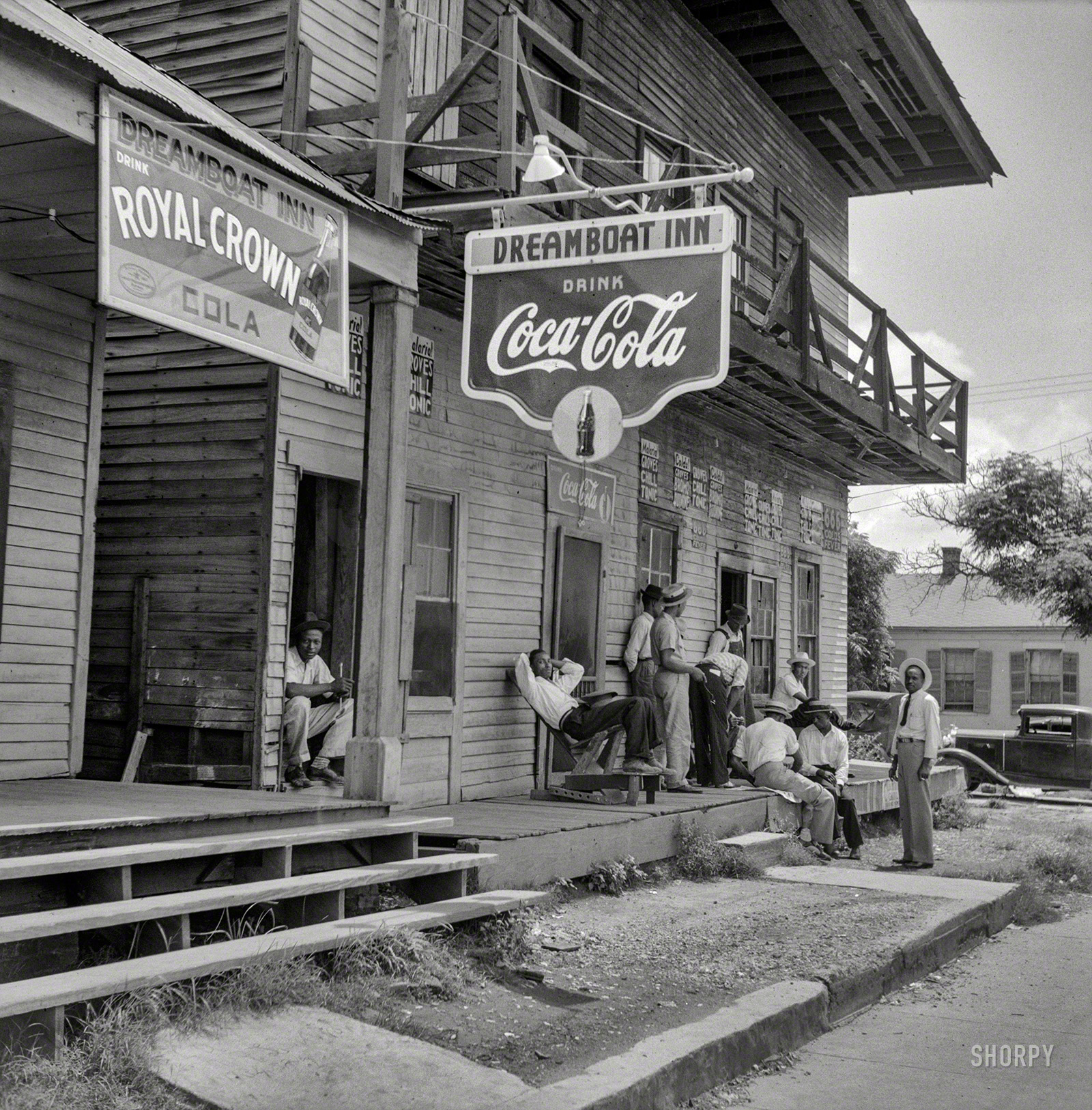 August 1940. "Port Gibson, Mississippi." The Dreamboat Inn, whose signage advertises anti-malarial tonics and two kinds of cola. Medium format negative by Marion Post Wolcott for the Resettlement Administration. View full size.