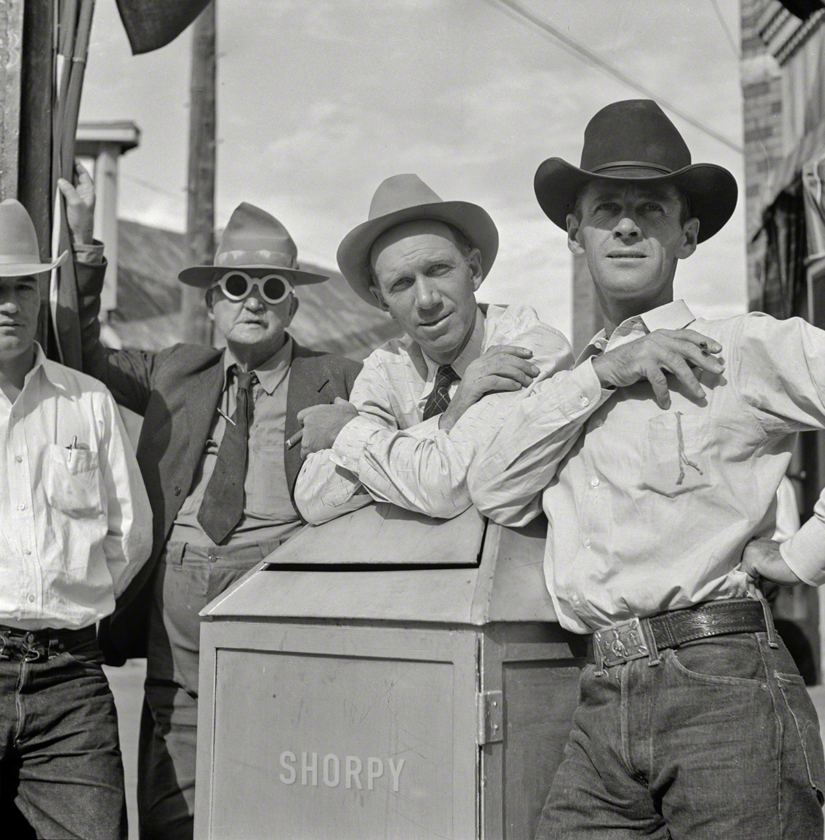 August 1941. "Stockmen on street corner outside bar 'The Mint.' Sheridan, Wyoming." Photo by Marion Post Wolcott. View full size.