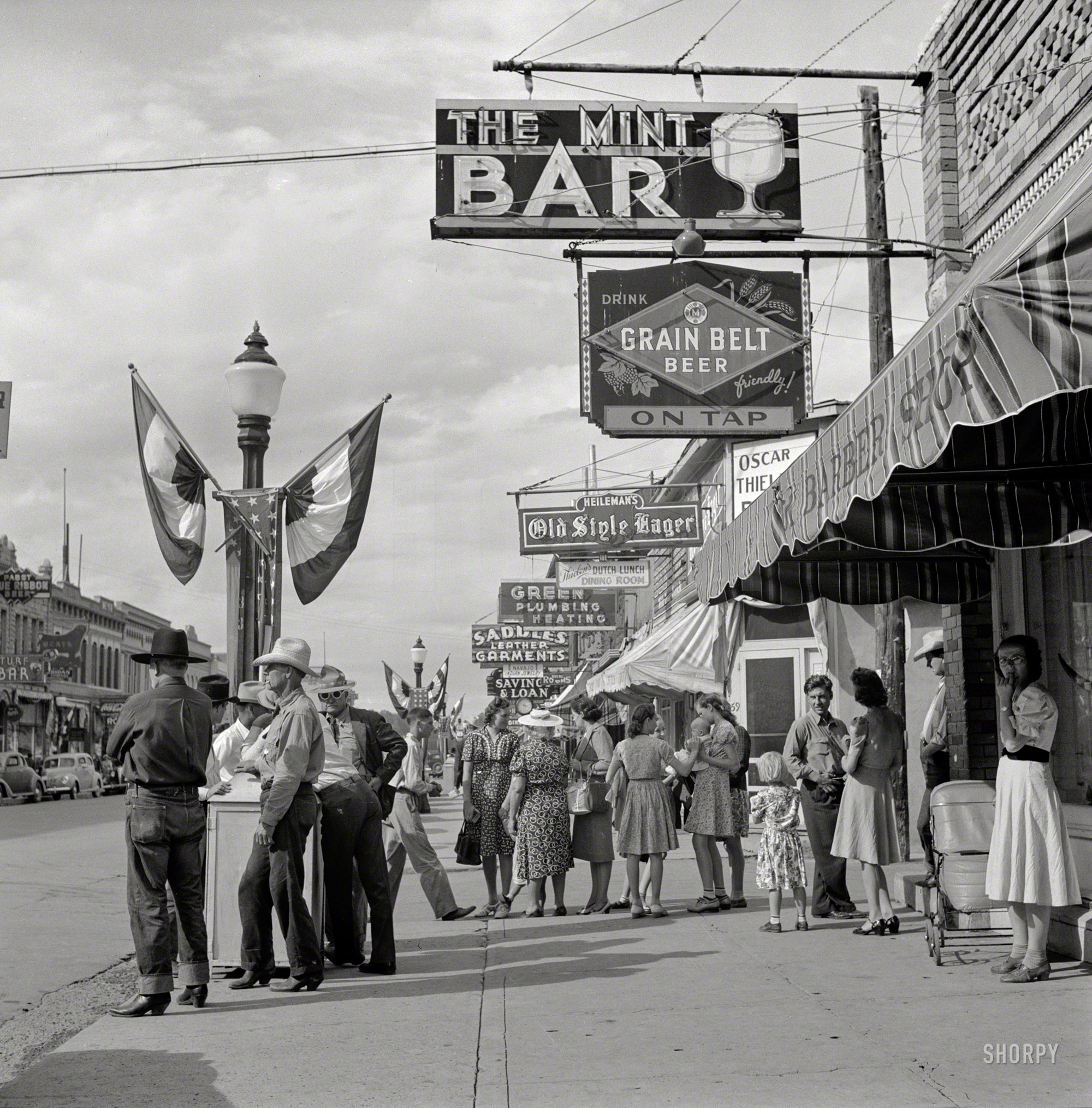 August 1941. "Main Street. Sheridan, Wyoming." An oasis of Western watering holes. Medium format negative by Marion Post Wolcott. View full size.