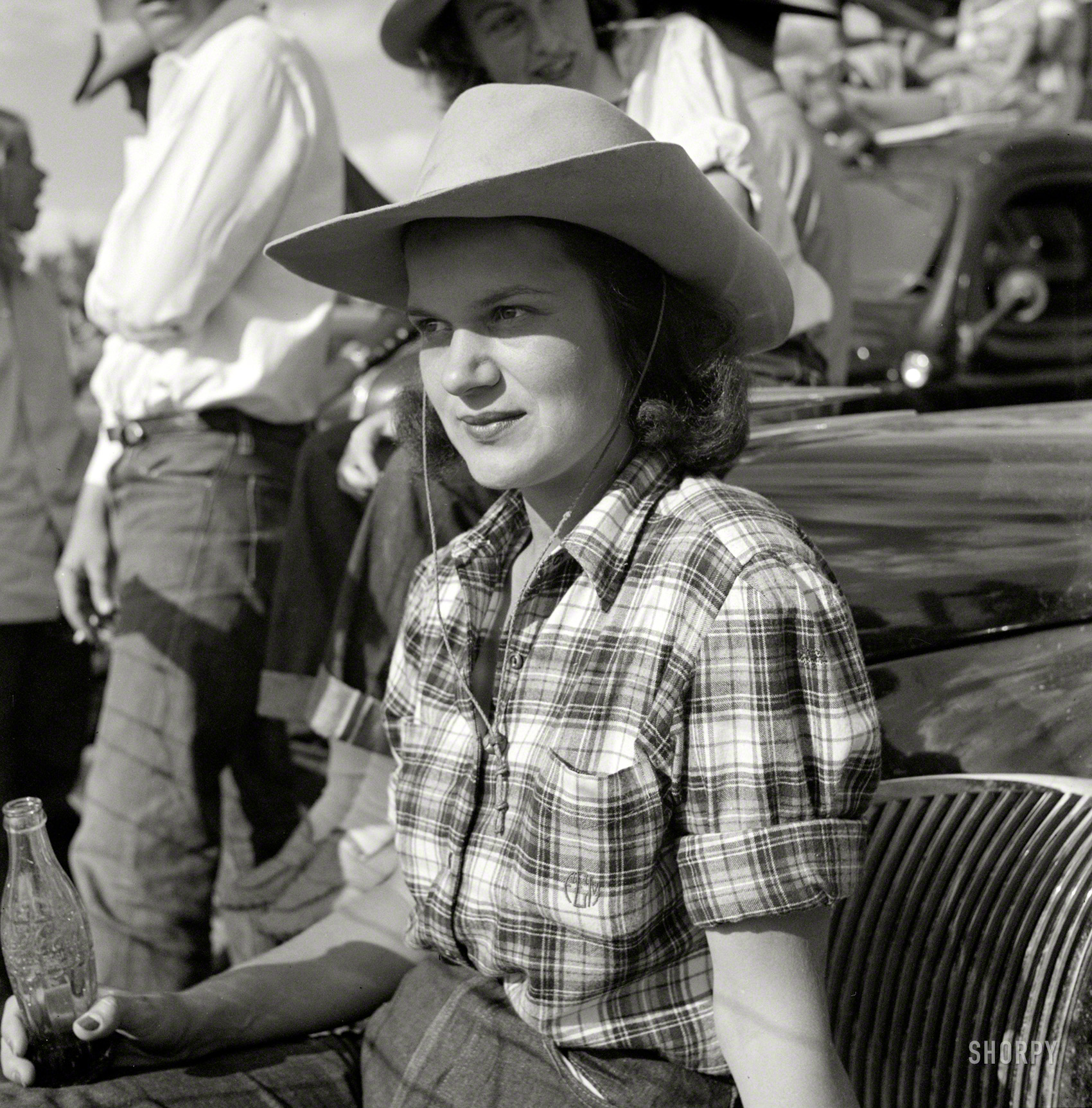 August 1941. "Dude from Quarter Circle U Ranch watching the rodeo at the Crow Agency Indian fair. Big Horn County, Montana." Medium format negative by Marion Post Wolcott for the Farm Security Administration. View full size.