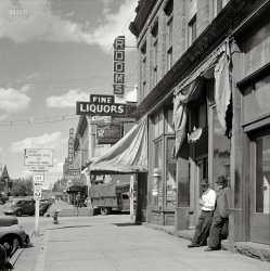 September 1941. "Main street of old mining town. Leadville, Colorado." Photo by Marion Post Wolcott for the Farm Security Administration. View full size.
Carlton Tunnel / Colorado 104When I went to try to locate what intersection this was, I learned that the Carlton Tunnel collapsed in 1943 (two short years after this photo was taken), with the end result being the decommissioning of Colorado Route 104.
"SH 104 is an original 1920s highway, and went from SH 82 at Basalt, east via the Fryingpan River to Meredith, through the Carlton Tunnel (toll), to US 24 at Leadville. There was a tunnel collapse in 1943, and SH 104 was decommissioned by 1950."
http://www.mesalek.com/colo/r100-119.html
Not too much differentThe bar is now called the Manhattan Bar. The building has some different architectural detail, but I'm positive it's the same building. The town is still old, some refurbished, but really, not too much going on.
I took a photo of it last year.
https://flic.kr/p/gxY2hX
Yep !you are in the right town if you want a drink or a meal. 
Yeast and WestI never would have guessed that Grain Belt Beer, at this time anyway, had a distribution network that went as far as Colorado. And west of Denver at that! I thought it was strictly an upper Midwest brew, like (Jacob) Schmidt or Gluek.
Other way around with me.For most of my drinking career first came the liquor then came the fine(s)
Probably not the Manhattan BarI think the original here was taken a block south of Gwendeanne's photo. Fine Liquors and Rooms are in the "Iron Building" on the SE corner of Harrison and 6th. The Kobos building across the street is now a parking lot (or was in 2009 when Google last drove by). 
View Larger Map
Hydrant HatI've seen a lot of fire hydrants in my life, but never one with a device like the one on top here.
[Here's another, from 1905. Details here. - Dave]
Definitely not the Manhattan The Manhattan, Kobos and Fine Liquors can be seen here.
(The Gallery, M.P. Wolcott, Mining, Stores & Markets)