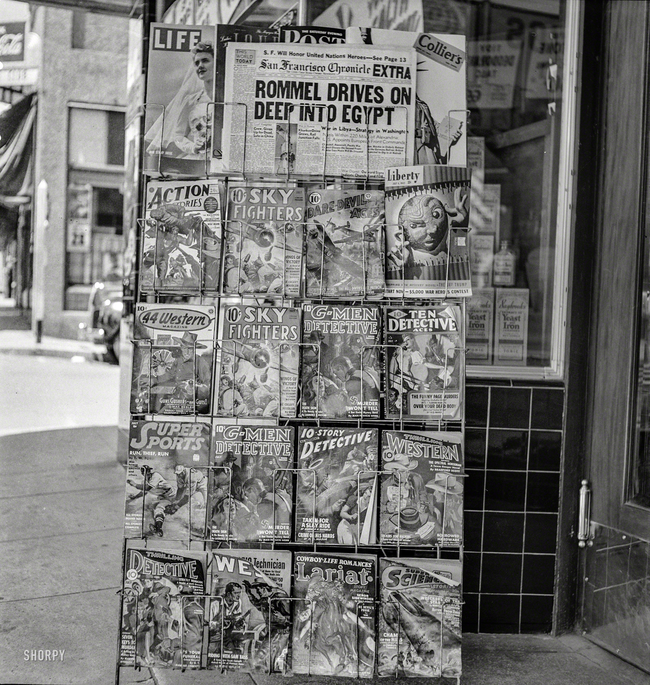 June 26, 1942. "Yreka, California. Magazine stand." Medium format negative by Russell Lee for the Office of War Information. View full size.