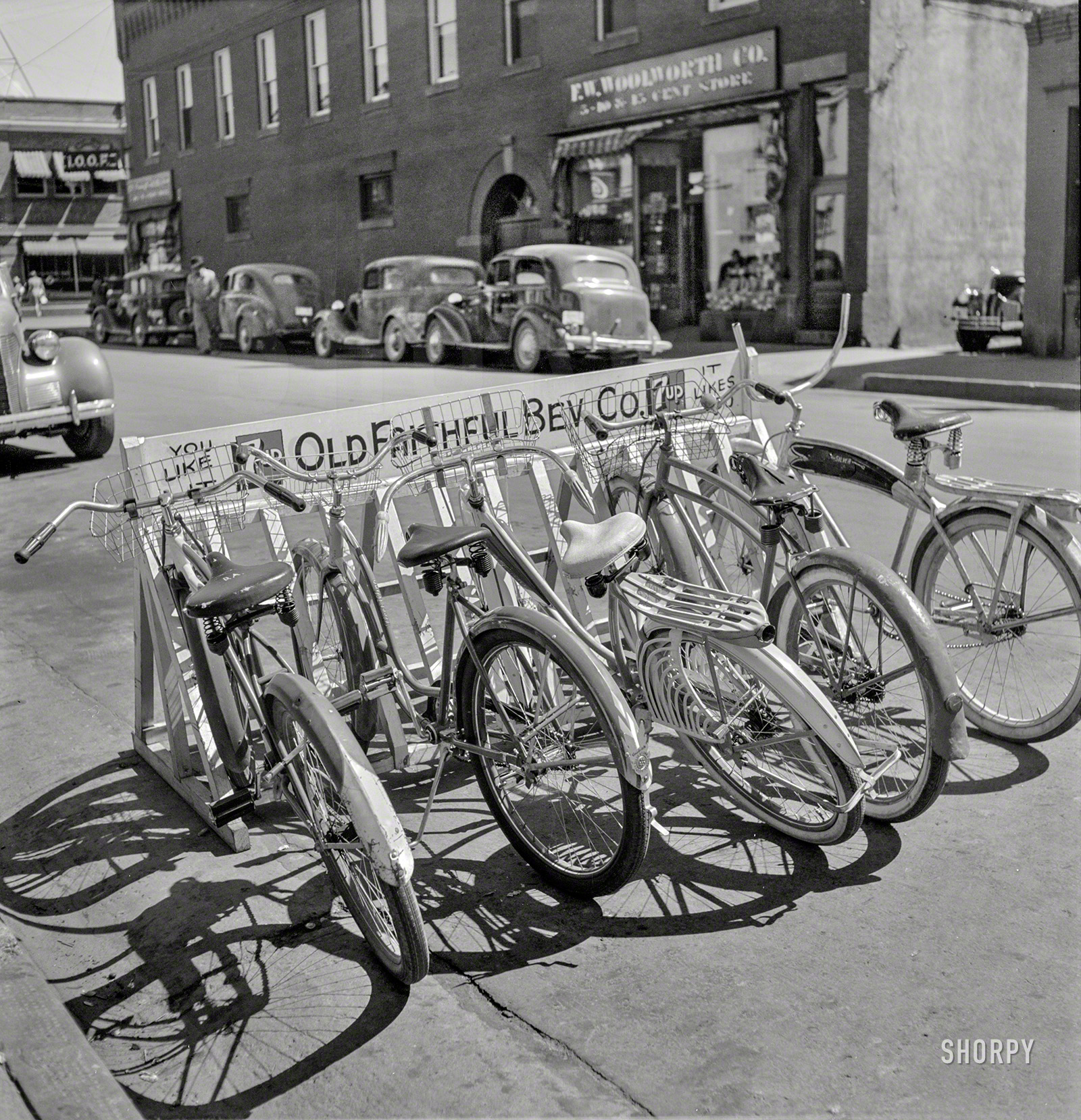 August 1942. "Bike rack in Idaho Falls, Idaho." Brought to you by 7up. Medium format negative by Russell Lee for the Office of War Information. View full size.