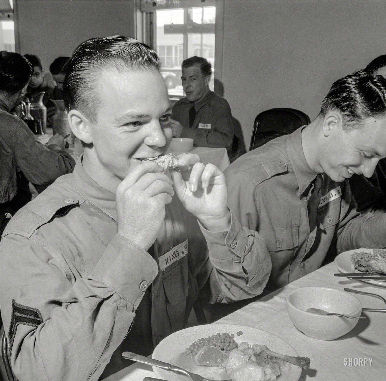 August 1941. "Chickens raised by FSA borrowers is good right down to the bone. Sunday dinner for flying cadets at Craig Field, Selma, Alabama." Medium format negative by John Collier for the Farm Security Administration. View full size.