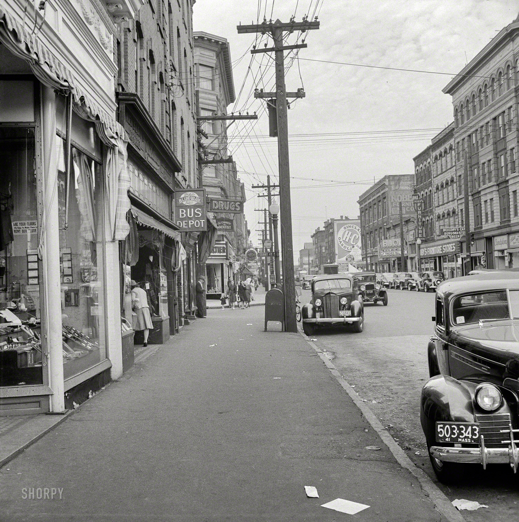 October 1941. "Main Street, Holyoke, Massachusetts." Home to the Deluxe Blueway Lines bus depot and, across the street, the movie palace also seen here. Medium format nitrate negative by John Collier. View full size.