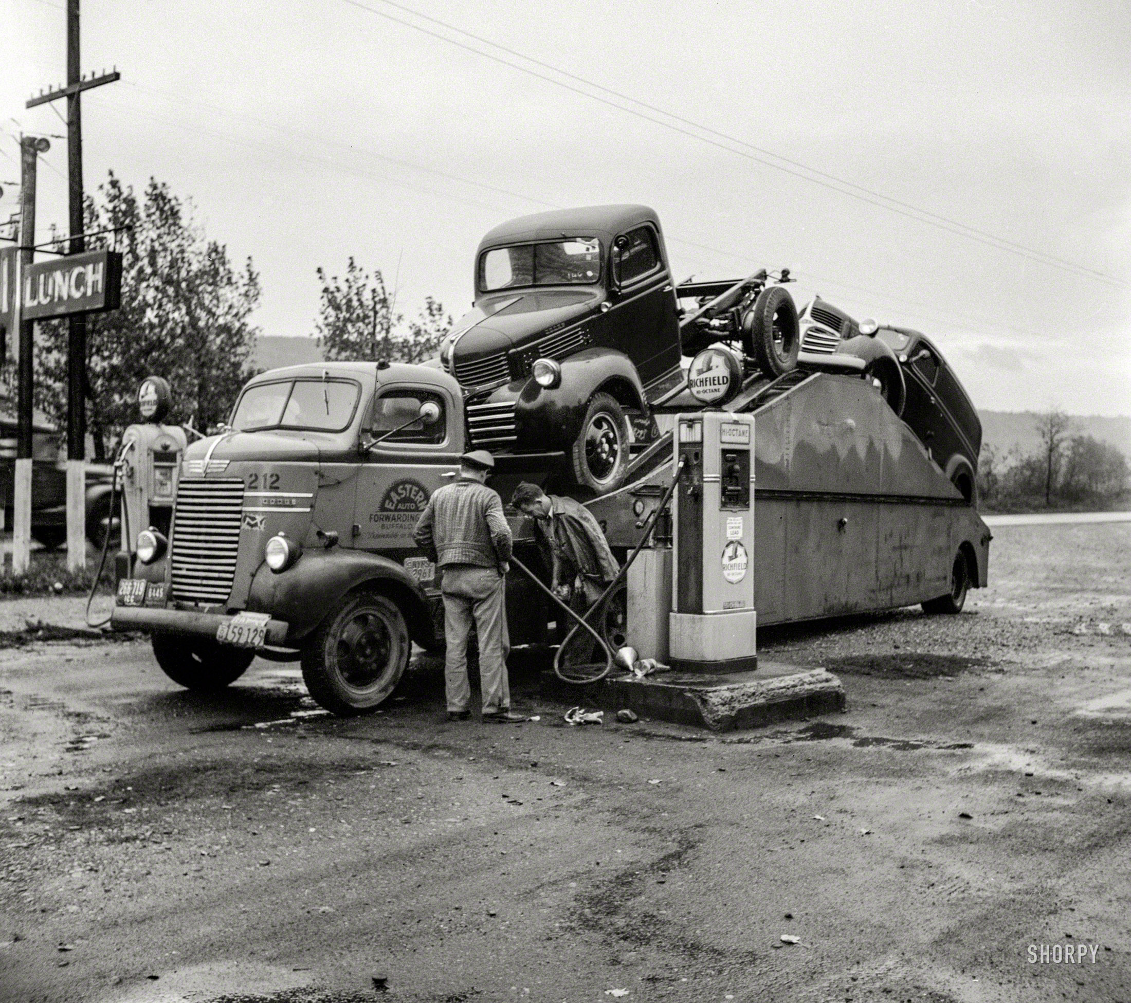 October 1941. "Car transport filling up with gas at Little Falls, New York." Medium format negative by John Collier. View full size.