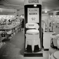 &nbsp; &nbsp; &nbsp; &nbsp; Its big 8-sheet porcelain tub is insulated to keep water warm! Streamlined 8-position wringer with soft balloon rolls has chromium pressure controls; push-pull safety release; roll-stop safety dry feed rest and automatic water-return board.
October 1941. "Washer for sale. Sears Roebuck store at Syracuse, New York." Medium format negative by John Collier. View full size.